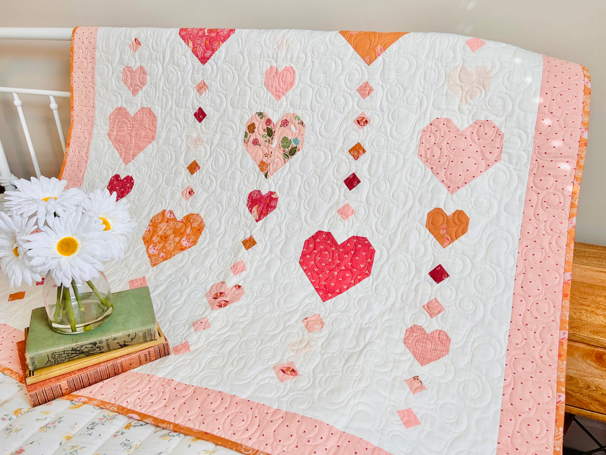 Heart on a String quilt draped over a chair