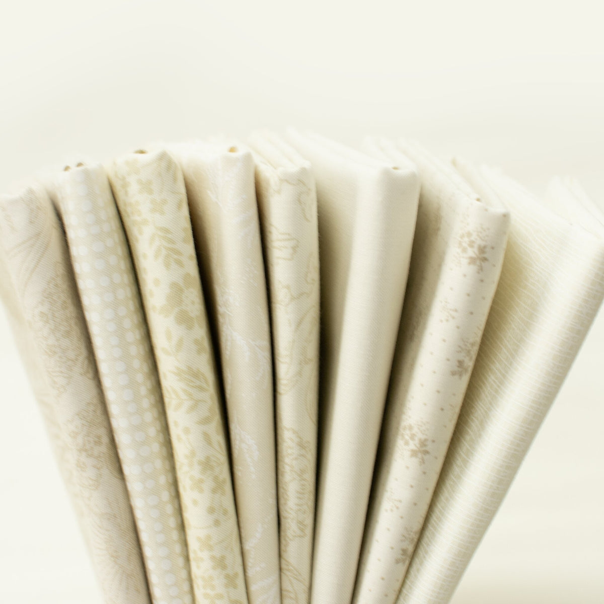 Blue Skies Cloud Cover half yard bundle: 8 cream Moda half yards fanned out