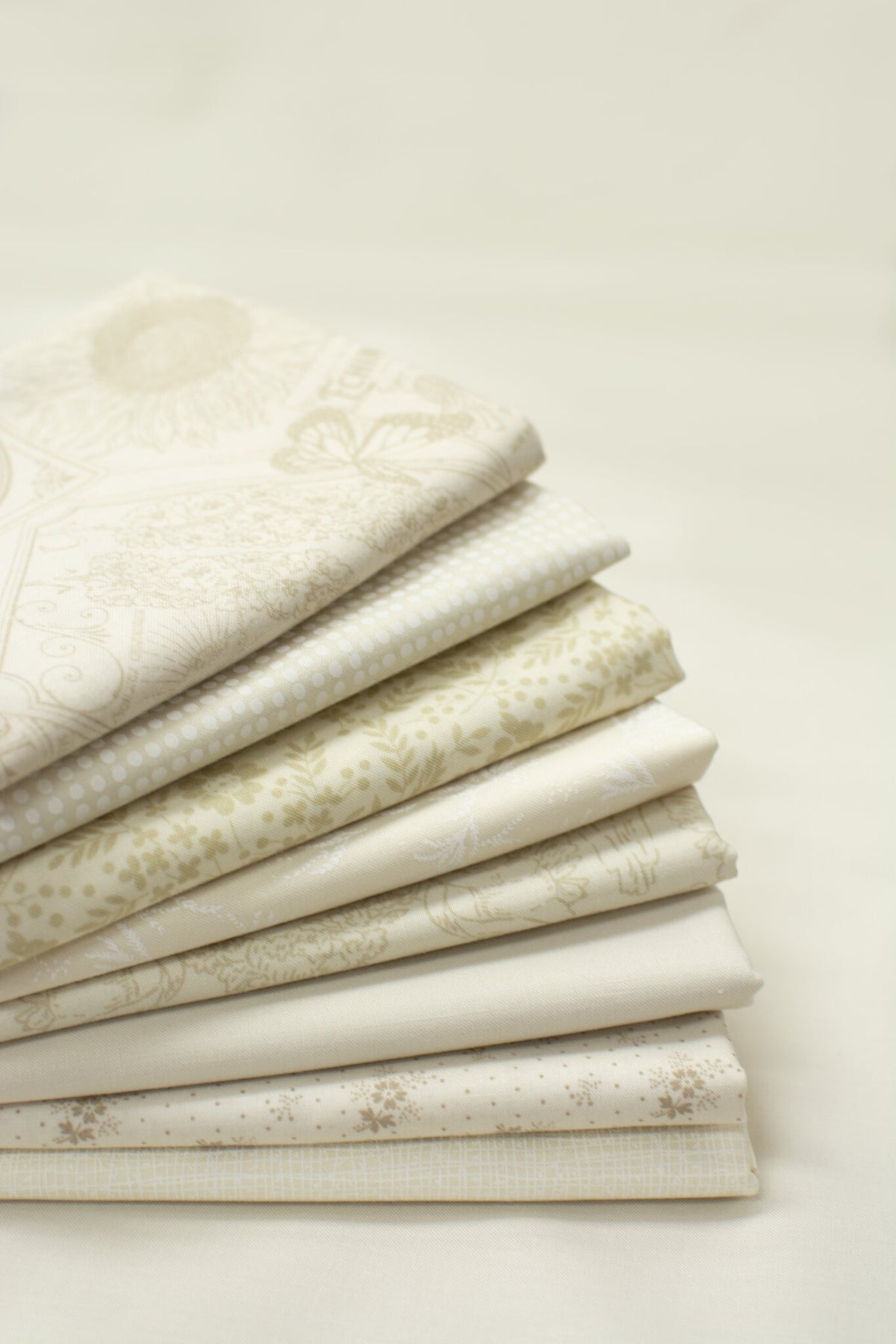 Cloud Cover cream half yards stacked, background option for the Blue Skies Shine So Bright quilt kit
